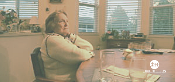 Mom With Alzheimer's Sitting At Table